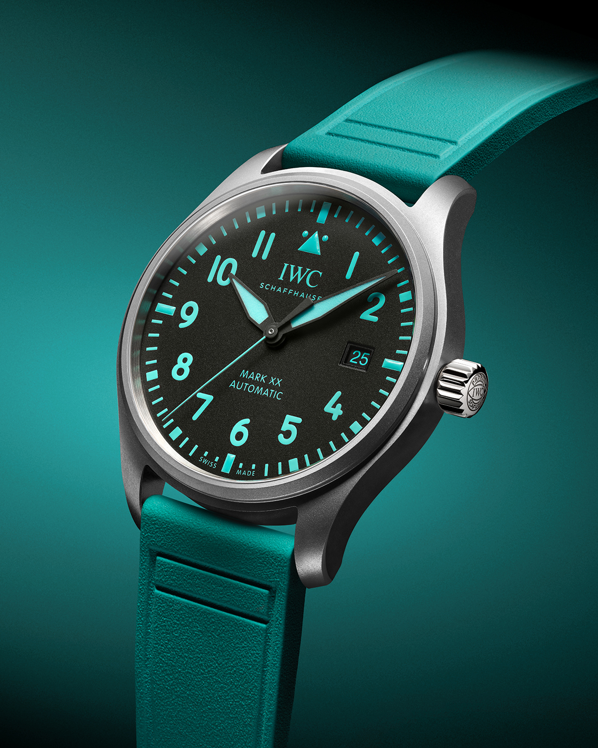 A teal watch with a black dial surrounded by a teal background. The watch is angled toward the left side of the photo.